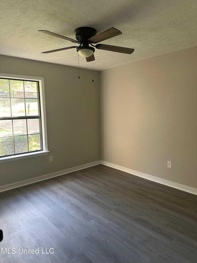 empty room with wood finished floors, a textured ceiling, baseboards, and ceiling fan