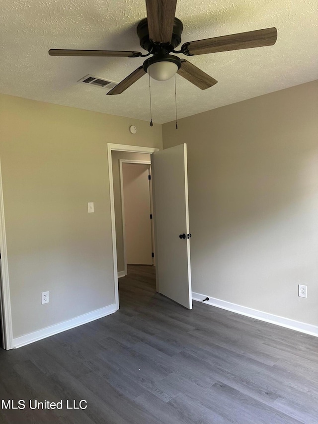 unfurnished room with ceiling fan, hardwood / wood-style flooring, and a textured ceiling