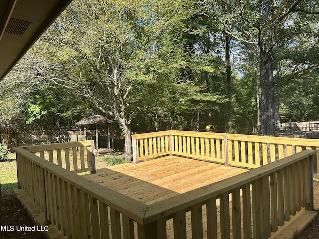 wooden terrace featuring a gazebo