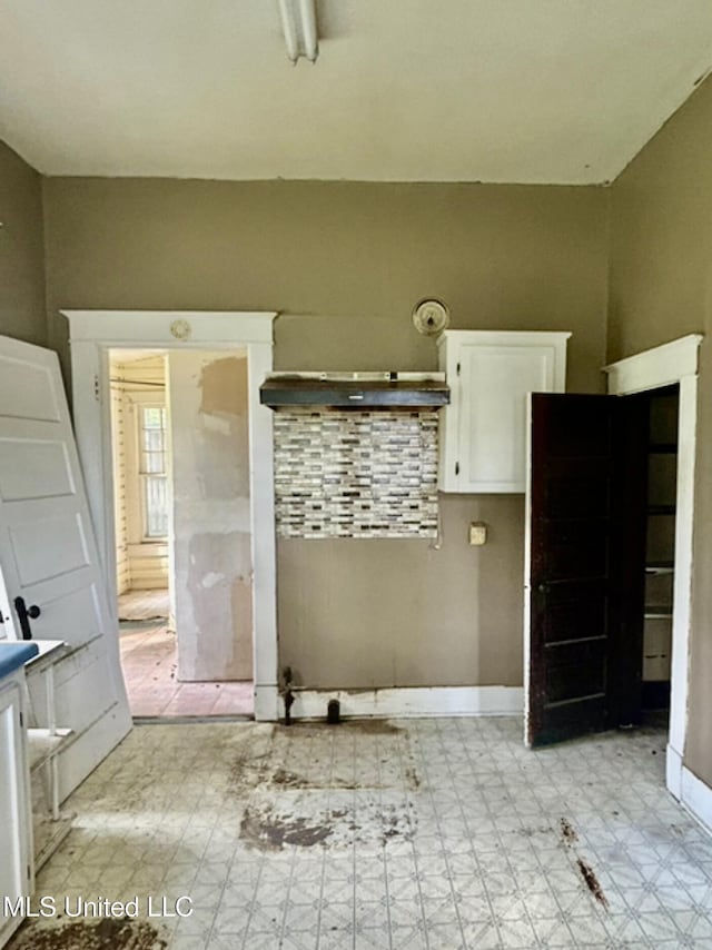2305 Grenada Blvd, Greenwood, MS 38930 - kitchen with light flooring and white cabinetry
