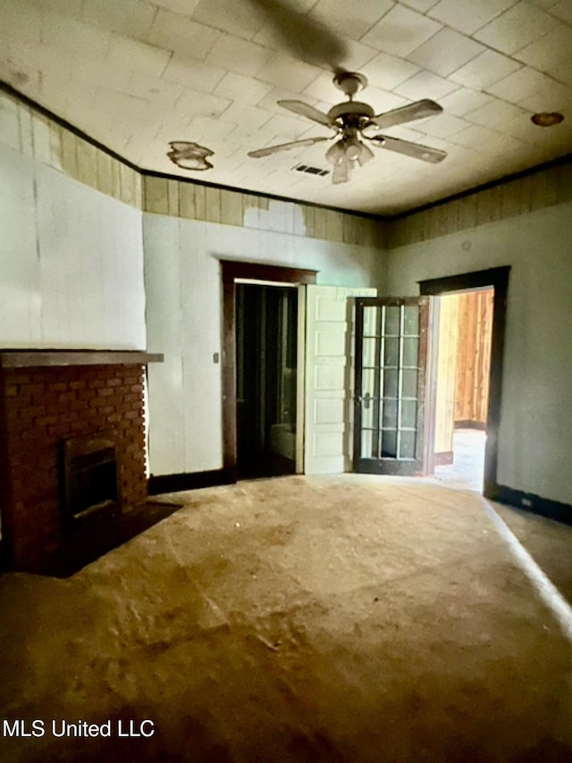 2305 Grenada Blvd, Greenwood, MS 38930 - unfurnished living room featuring a brick fireplace and a ceiling fan