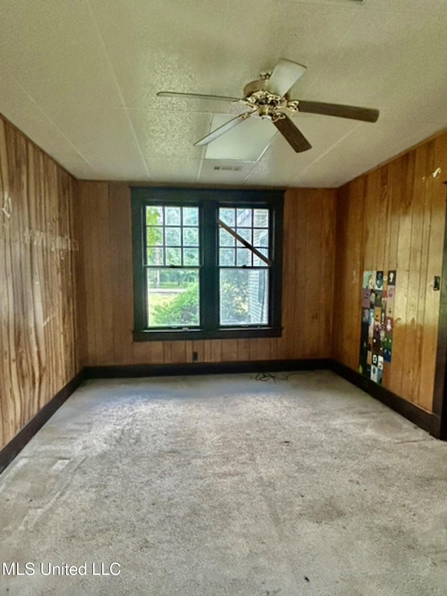 2305 Grenada Blvd, Greenwood, MS 38930 - carpeted empty room featuring wood walls and a textured ceiling