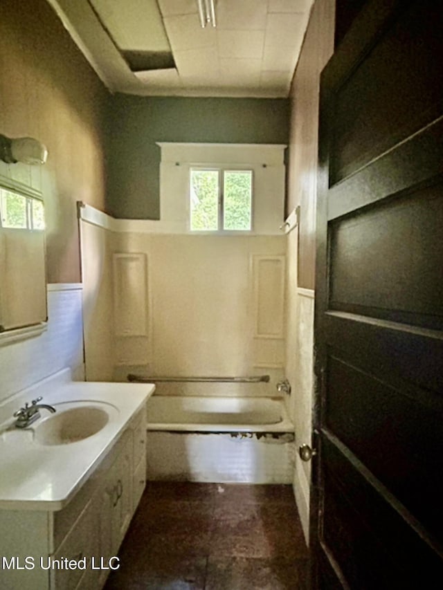 2305 Grenada Blvd, Greenwood, MS 38930 - bathroom featuring healthy amount of natural light, vanity,  shower combination, and a wainscoted wall