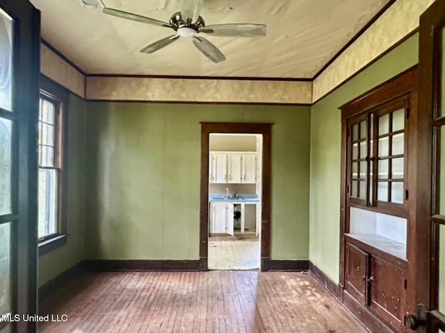 2305 Grenada Blvd, Greenwood, MS 38930 - spare room featuring hardwood / wood-style flooring, ceiling fan, and crown molding