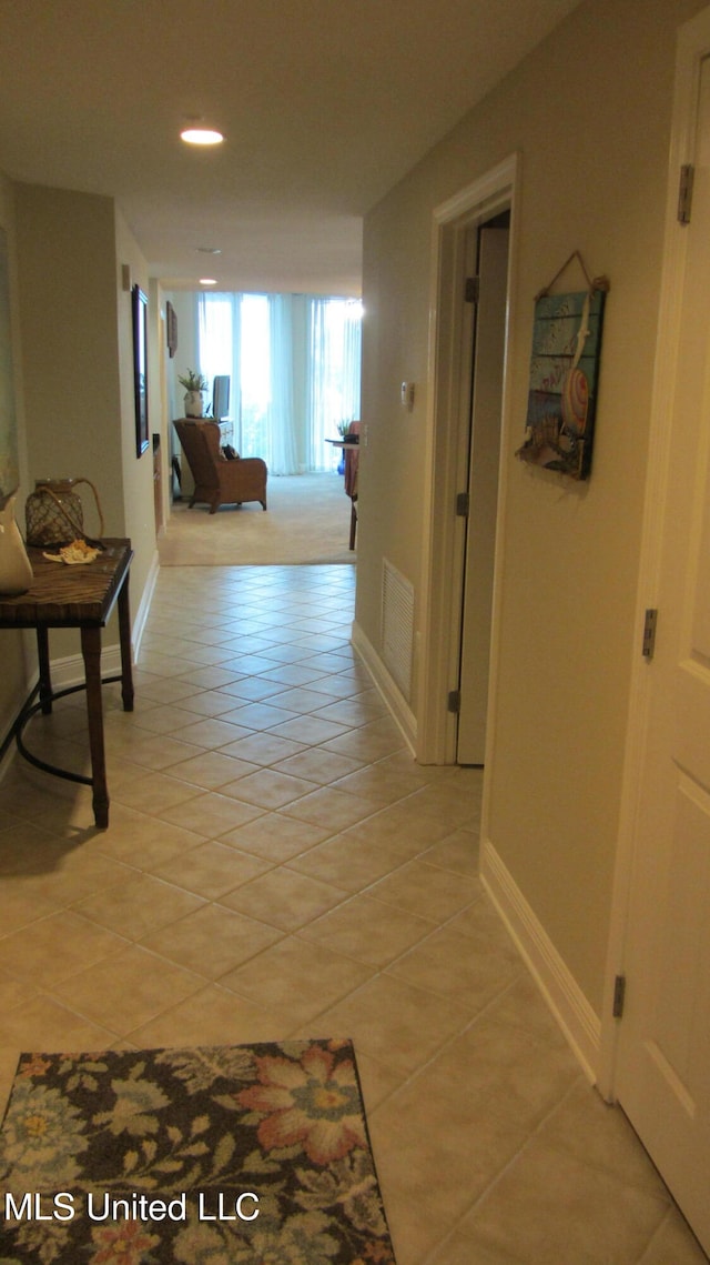 hallway with light tile patterned floors