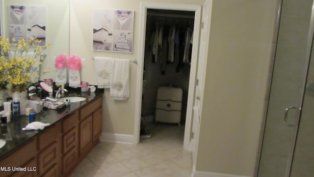 bathroom with walk in shower and vanity