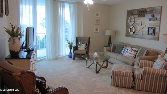 carpeted living room with ceiling fan and a healthy amount of sunlight