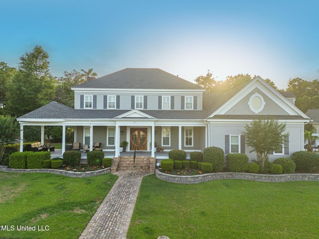 2011 Pointe Clear Dr, Biloxi, MS 39531 - view of front of property with covered porch, a front lawn, and a shingled roof