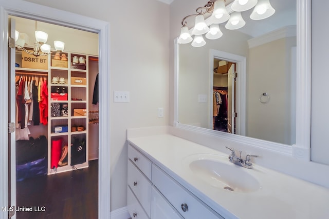 2011 Pointe Clear Dr, Biloxi, MS 39531 - bathroom with a chandelier, vanity, and a walk in closet