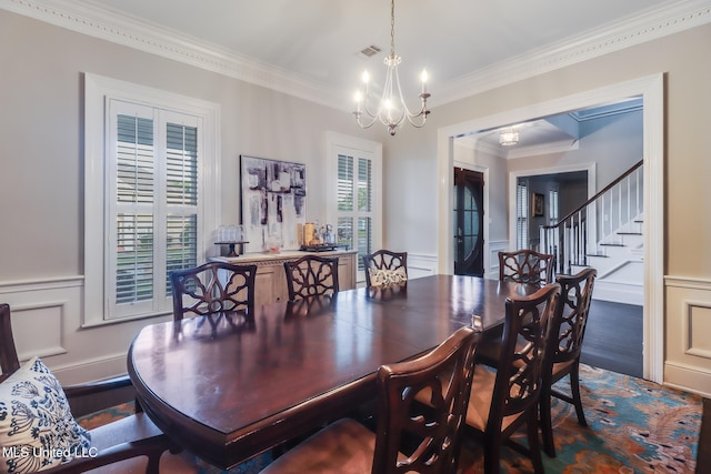 2011 Pointe Clear Dr, Biloxi, MS 39531 - dining room with a chandelier, a decorative wall, crown molding, a wainscoted wall, and stairs