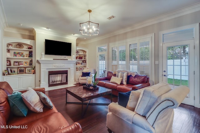 2011 Pointe Clear Dr, Biloxi, MS 39531 - living room featuring a chandelier, crown molding, hardwood / wood-style floors, a fireplace with flush hearth, and built in features