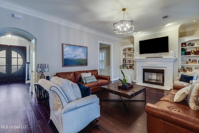 2011 Pointe Clear Dr, Biloxi, MS 39531 - living area featuring crown molding, a chandelier, hardwood / wood-style flooring, arched walkways, and built in shelves