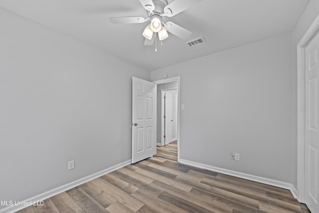 unfurnished bedroom featuring wood-type flooring and ceiling fan