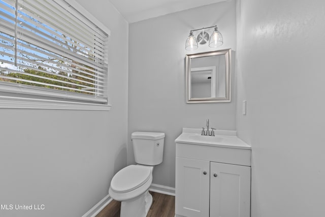 bathroom featuring hardwood / wood-style floors, vanity, and toilet