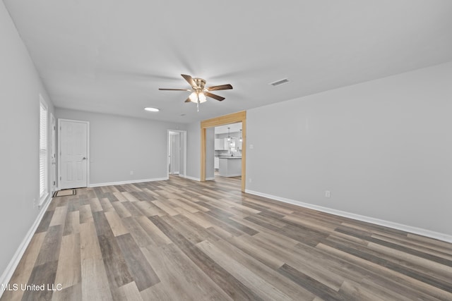 spare room with light hardwood / wood-style floors and ceiling fan