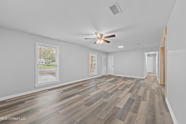 spare room with ceiling fan and wood-type flooring