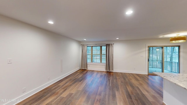 spare room featuring dark hardwood / wood-style flooring