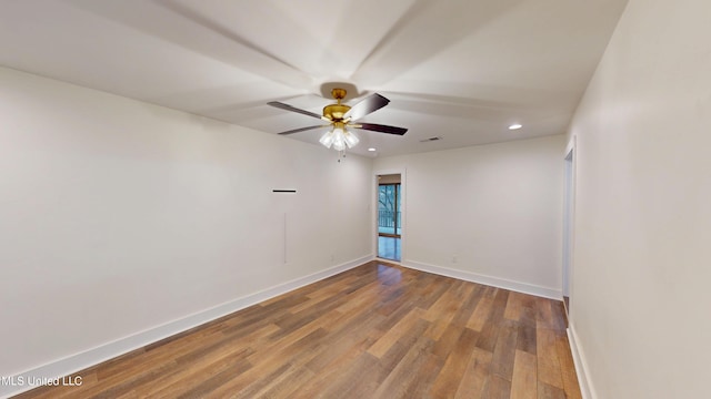 empty room with ceiling fan and wood-type flooring