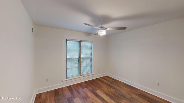 empty room with dark wood-type flooring and ceiling fan