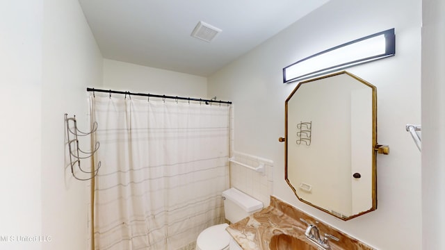 bathroom featuring vanity, toilet, and a shower with shower curtain