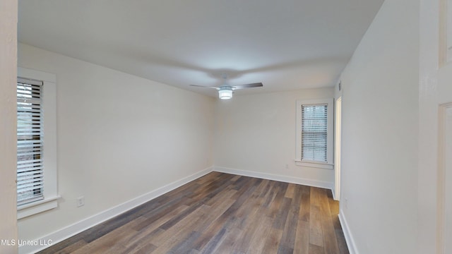 spare room with ceiling fan and dark hardwood / wood-style flooring