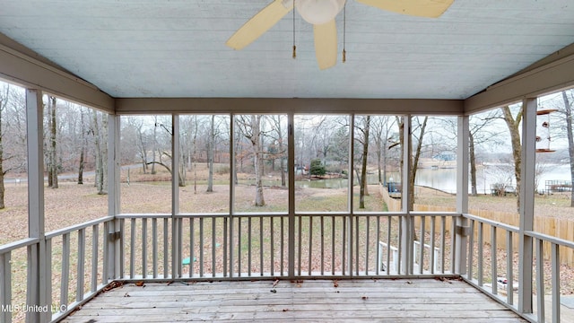 unfurnished sunroom featuring a water view, ceiling fan, and a wealth of natural light