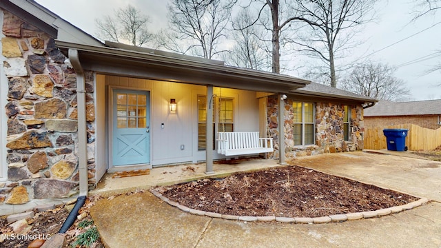 view of exterior entry with covered porch