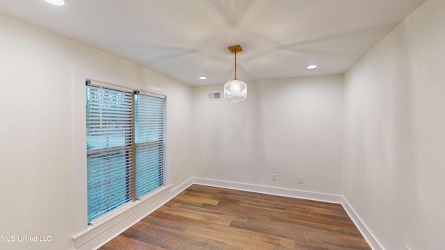 unfurnished room with dark hardwood / wood-style flooring