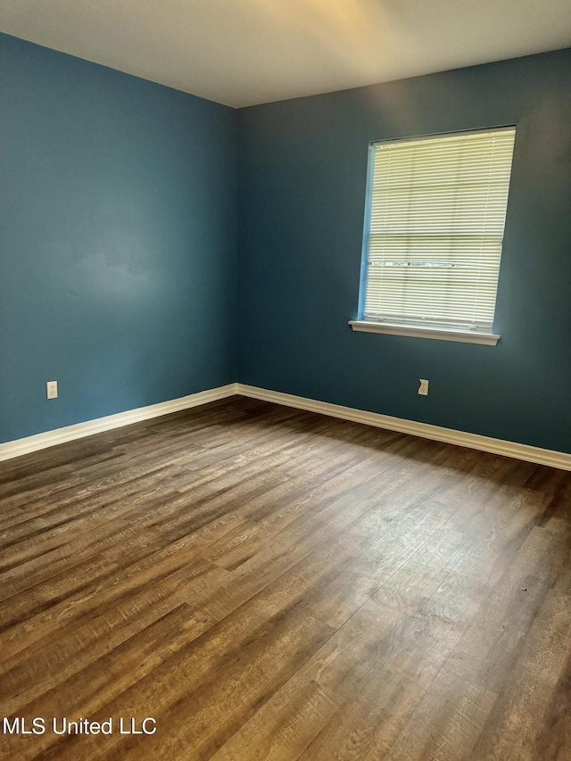 empty room featuring dark hardwood / wood-style floors