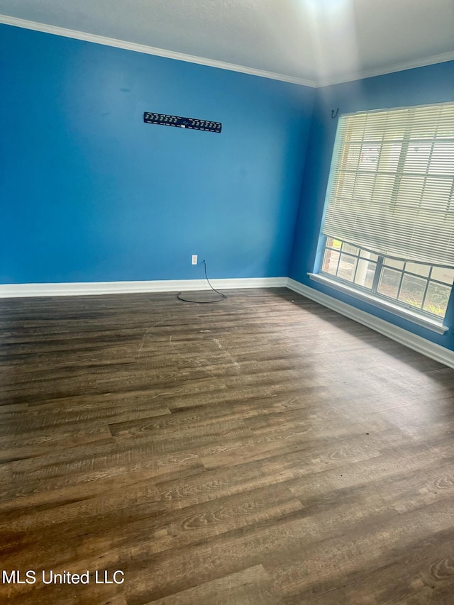 unfurnished room with crown molding and dark hardwood / wood-style flooring