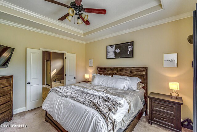 bedroom with ornamental molding, light carpet, ceiling fan, and a tray ceiling