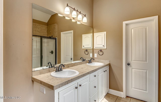 bathroom with walk in shower, vanity, and tile patterned flooring