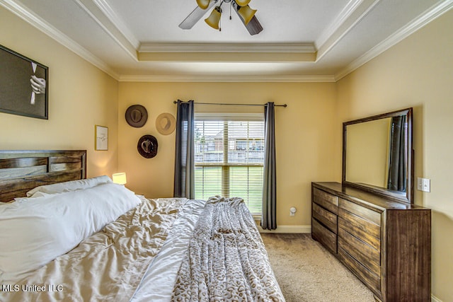 bedroom with a raised ceiling, light carpet, ceiling fan, and crown molding