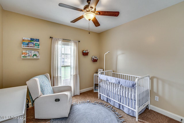 carpeted bedroom featuring a crib and ceiling fan