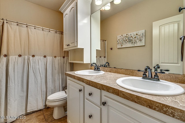 bathroom with vanity, tile patterned floors, and toilet