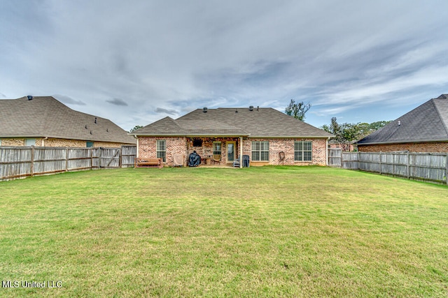 back of property featuring a lawn