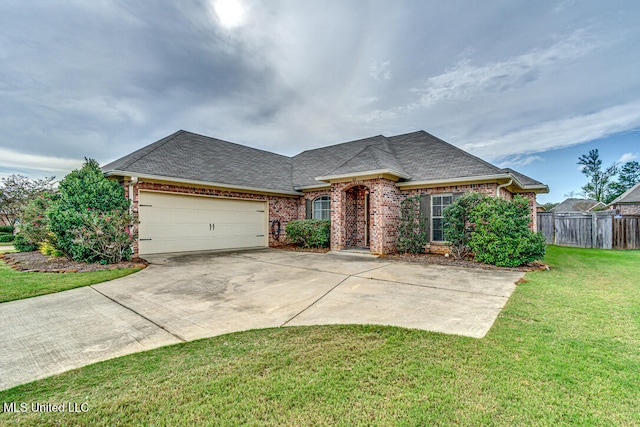 view of front of house featuring a garage and a front lawn