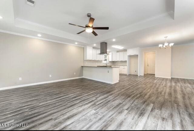 105 Leigh Cir, Ocean Springs, MS 39564 - unfurnished living room with a raised ceiling, dark wood finished floors, a chandelier, recessed lighting, and crown molding