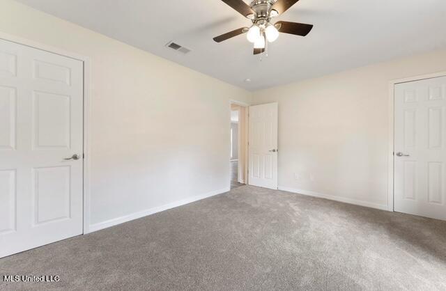 105 Leigh Cir, Ocean Springs, MS 39564 - unfurnished bedroom featuring carpet floors and a ceiling fan