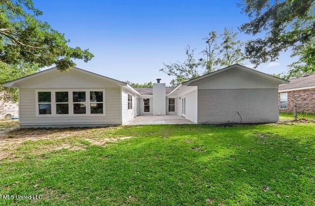 105 Leigh Cir, Ocean Springs, MS 39564 - rear view of property featuring a patio, a yard, and a chimney