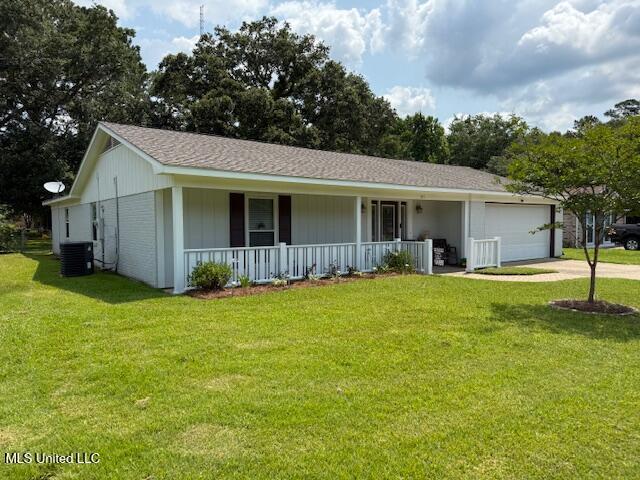 105 Leigh Cir, Ocean Springs, MS 39564 - ranch-style home with a porch, a garage, concrete driveway, and a front lawn