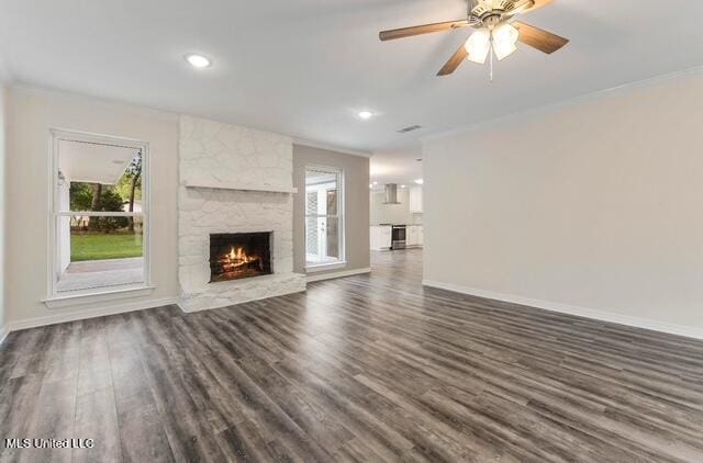 105 Leigh Cir, Ocean Springs, MS 39564 - unfurnished living room with healthy amount of natural light, dark wood finished floors, a fireplace, crown molding, and a ceiling fan
