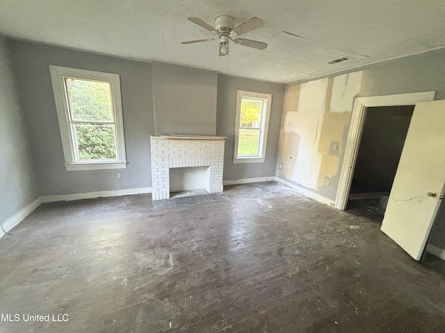 542 Rd Of Remembrance, Jackson, MS 39209 - unfurnished living room featuring plenty of natural light, a ceiling fan, a brick fireplace, and baseboards