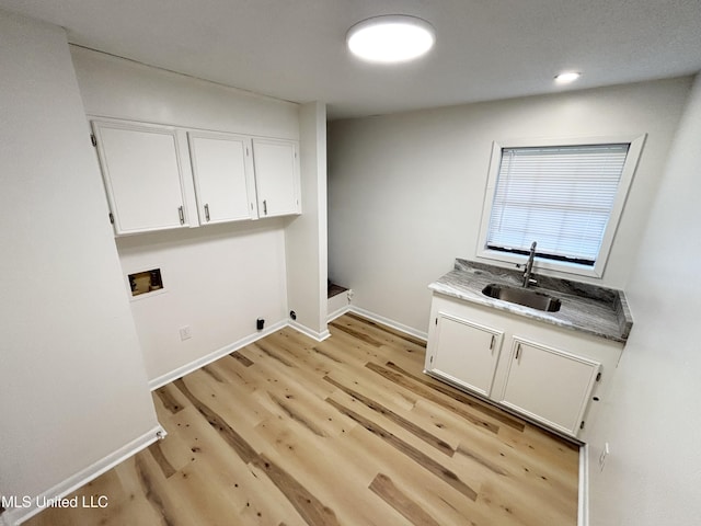 116 Victoria Cir, Newton, MS 39345 - laundry room featuring hookup for a washing machine, light wood-style flooring, baseboards, and cabinet space