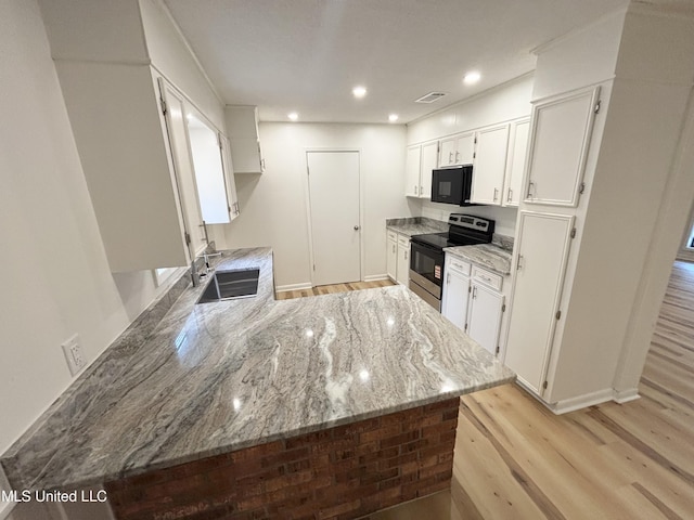 116 Victoria Cir, Newton, MS 39345 - kitchen featuring electric range, black microwave, a sink, light wood-style floors, and recessed lighting
