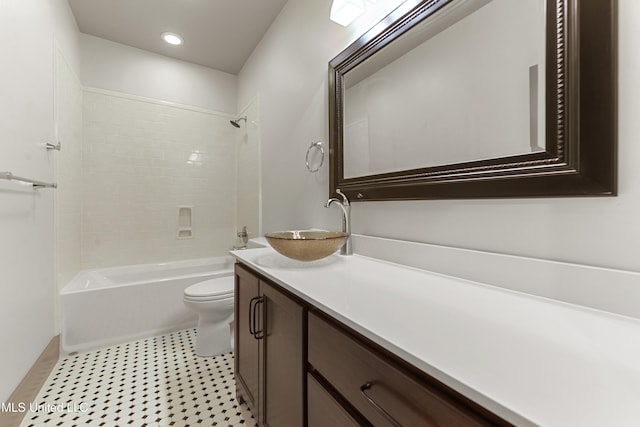 full bathroom featuring vanity, toilet, and tiled shower / bath