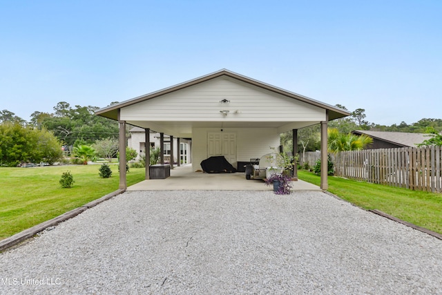 view of front facade featuring a front yard and a carport