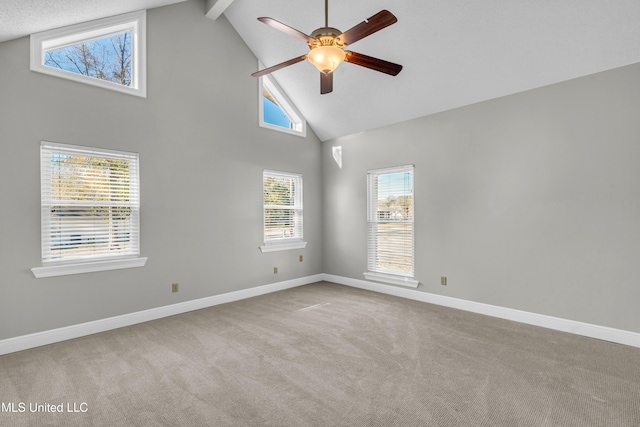 empty room with beam ceiling, high vaulted ceiling, ceiling fan, and light colored carpet