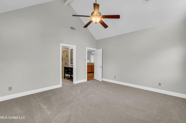 unfurnished bedroom featuring light carpet, ceiling fan, beam ceiling, high vaulted ceiling, and connected bathroom