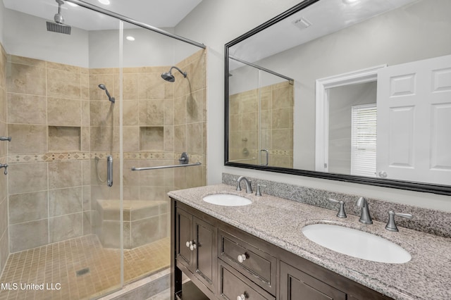 bathroom featuring vanity and a shower with shower door